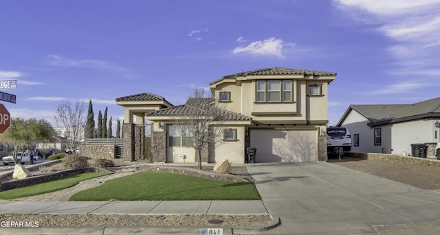 mediterranean / spanish house with a garage and a front lawn