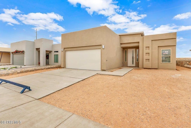 pueblo-style home featuring a garage