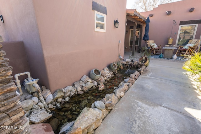 view of property exterior featuring a patio area