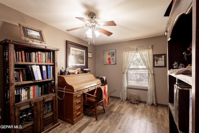 misc room with hardwood / wood-style flooring and ceiling fan