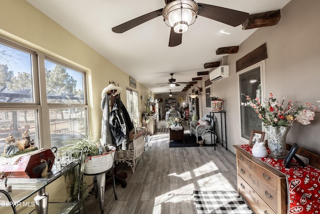 sunroom / solarium featuring a wall mounted AC and ceiling fan