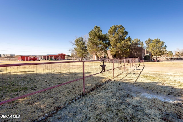 view of yard featuring an outdoor structure and a rural view