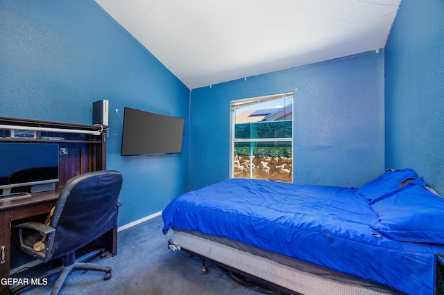 carpeted bedroom with lofted ceiling