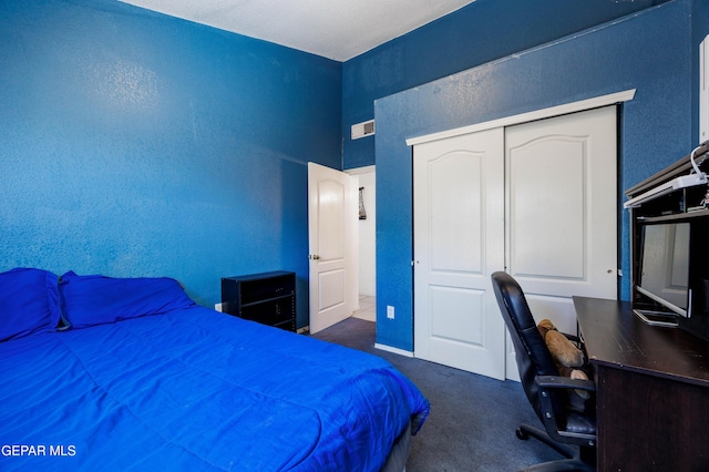 bedroom featuring dark carpet and a closet