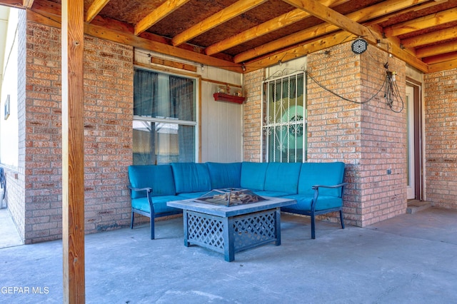 view of patio / terrace with an outdoor living space with a fire pit