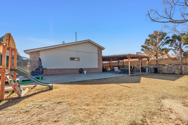 exterior space with a playground, a patio area, and a trampoline