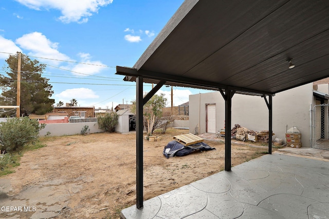 view of patio with a storage shed