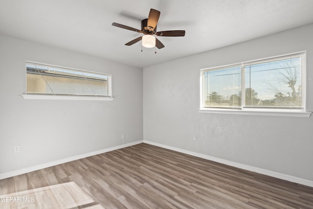 empty room featuring hardwood / wood-style flooring and ceiling fan