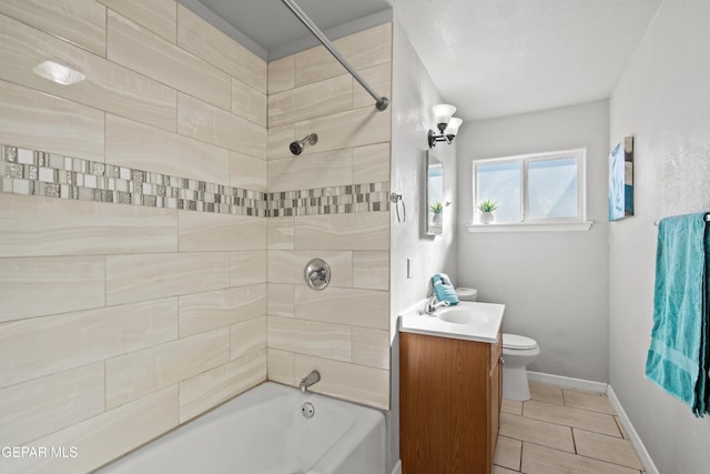 full bathroom featuring tiled shower / bath combo, vanity, and toilet