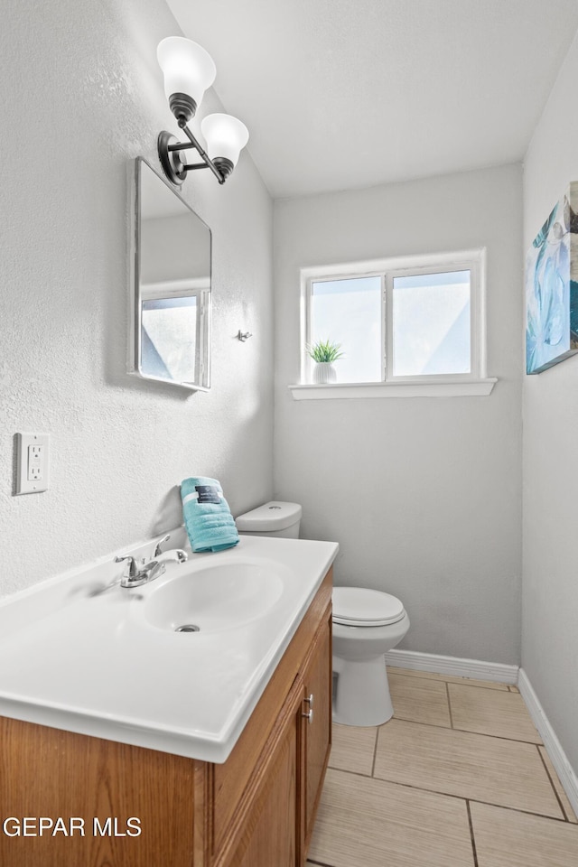 bathroom with toilet and vanity