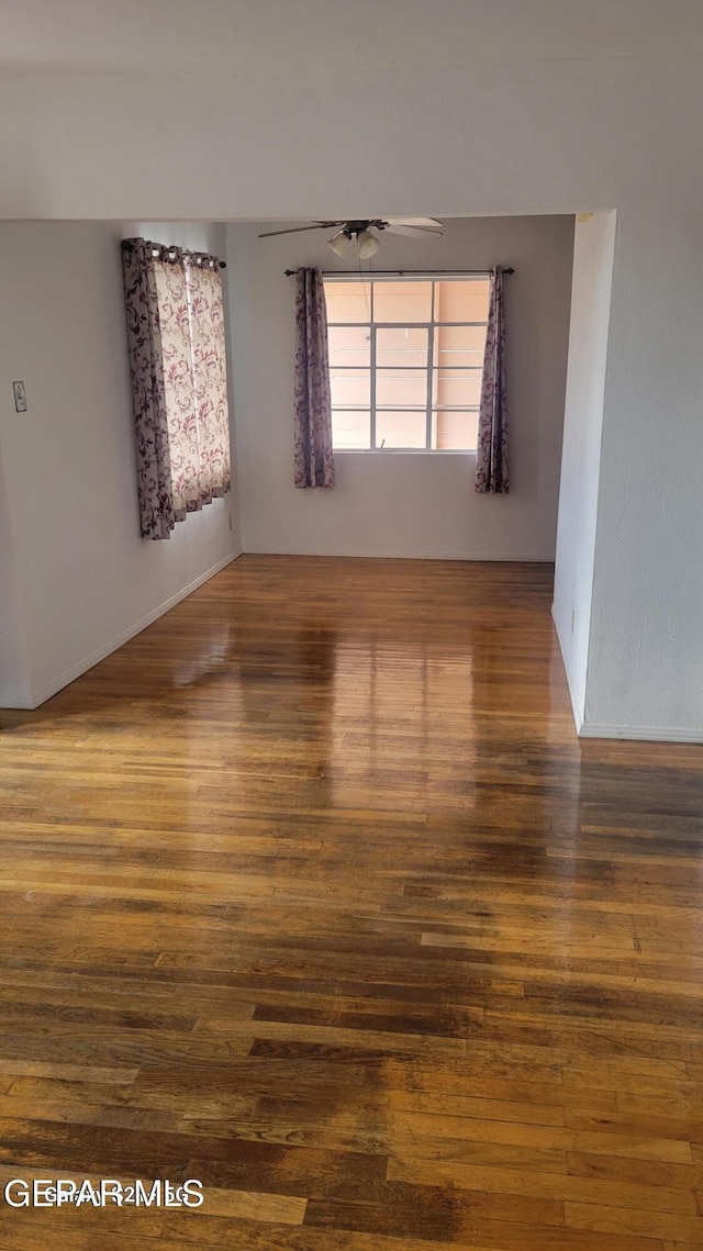 unfurnished room with hardwood / wood-style flooring