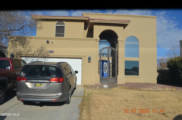 mediterranean / spanish house with a garage