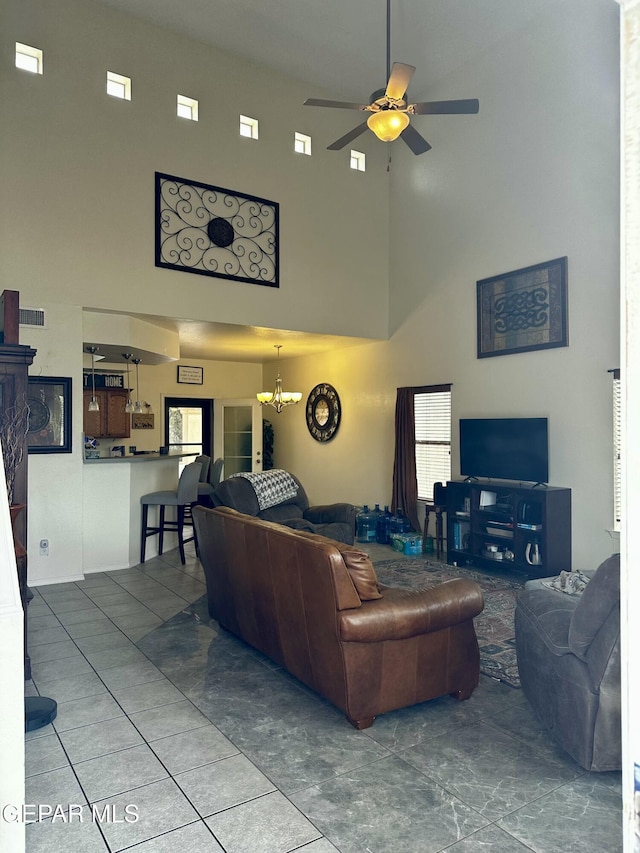 living room with ceiling fan with notable chandelier