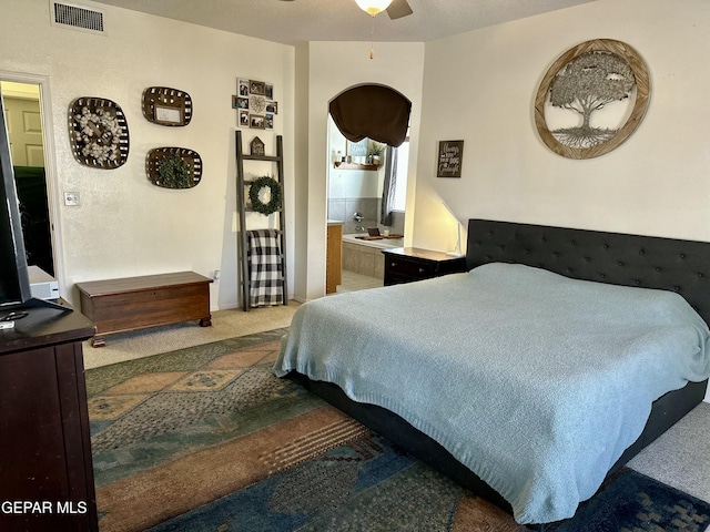 carpeted bedroom with connected bathroom