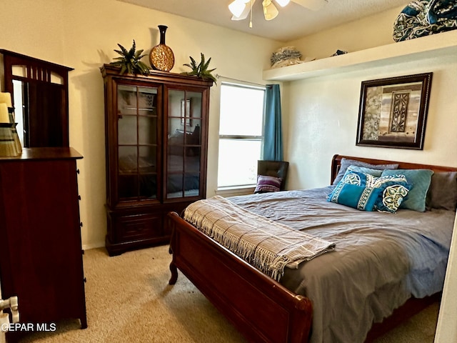 bedroom featuring ceiling fan and light colored carpet