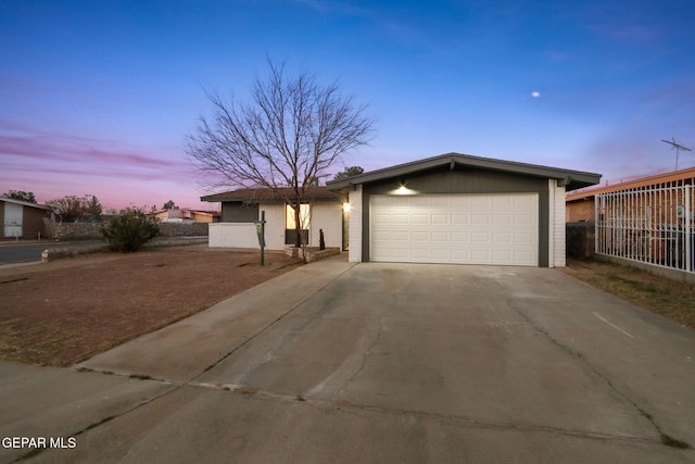 ranch-style house featuring a garage