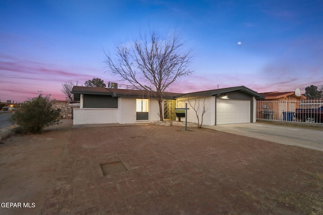 ranch-style home featuring a garage