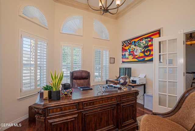 home office with crown molding, french doors, dark wood-type flooring, and an inviting chandelier