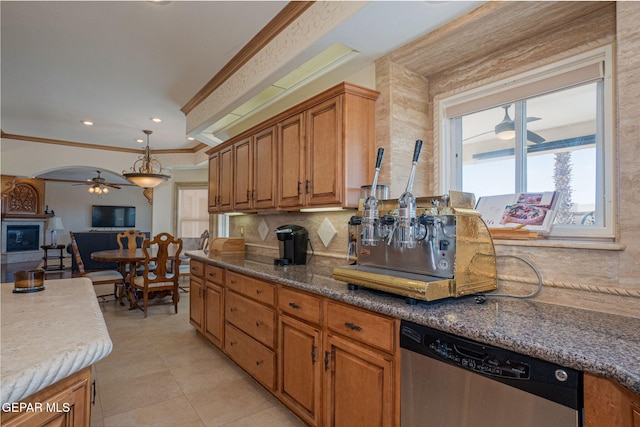 kitchen with ceiling fan, hanging light fixtures, stainless steel dishwasher, crown molding, and light tile patterned floors