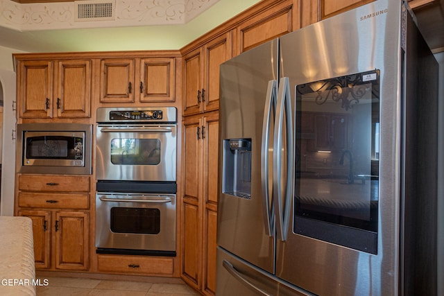 kitchen featuring appliances with stainless steel finishes and light tile patterned floors