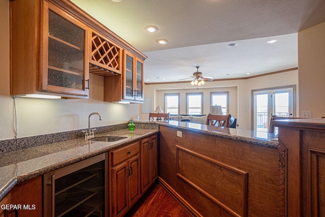 kitchen with ceiling fan, sink, wine cooler, dark hardwood / wood-style flooring, and crown molding