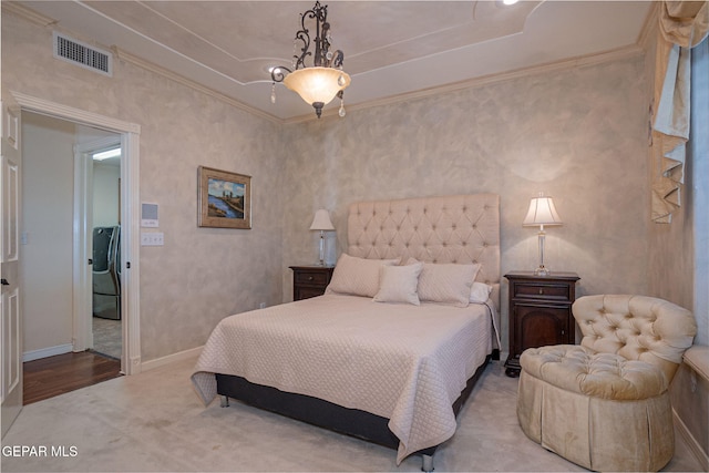 bedroom featuring light colored carpet, crown molding, and washer / dryer