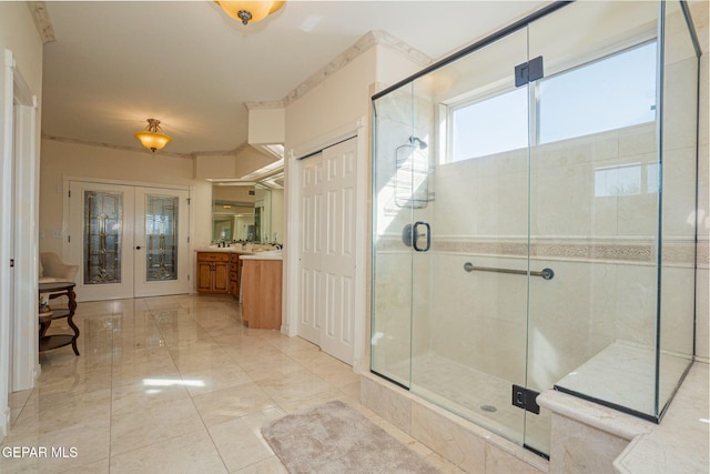 bathroom featuring vanity, an enclosed shower, and french doors