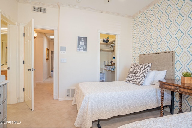 bedroom featuring carpet, a spacious closet, a closet, and ornamental molding