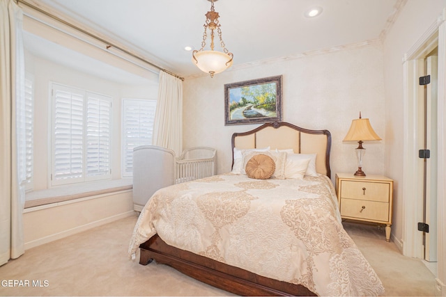 bedroom with light carpet and crown molding