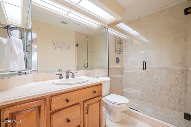 bathroom featuring tile patterned floors, vanity, toilet, and an enclosed shower