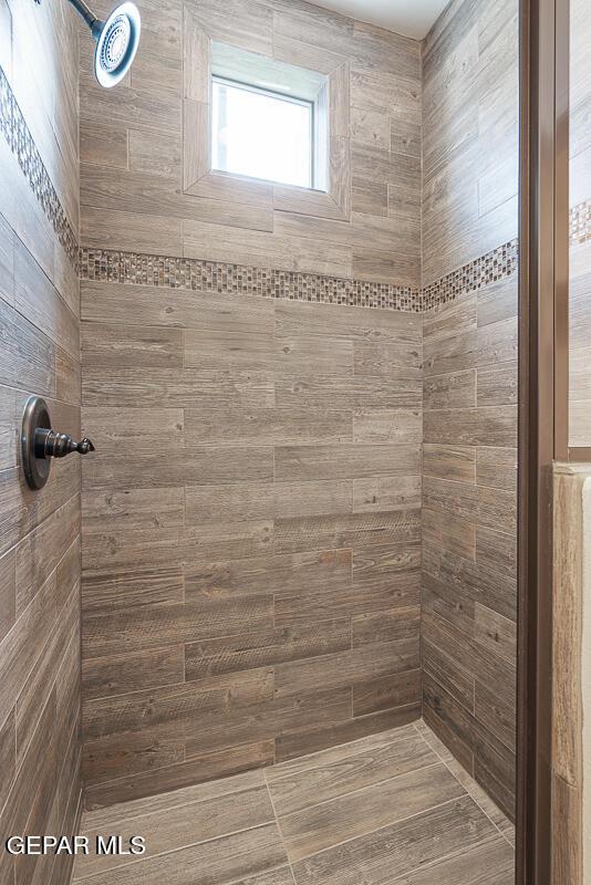 bathroom with a tile shower