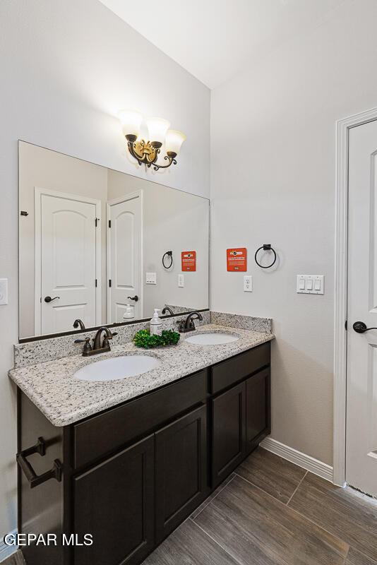 bathroom featuring vanity and a chandelier