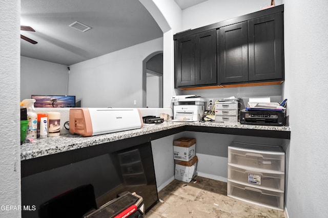 kitchen featuring light stone countertops and ceiling fan