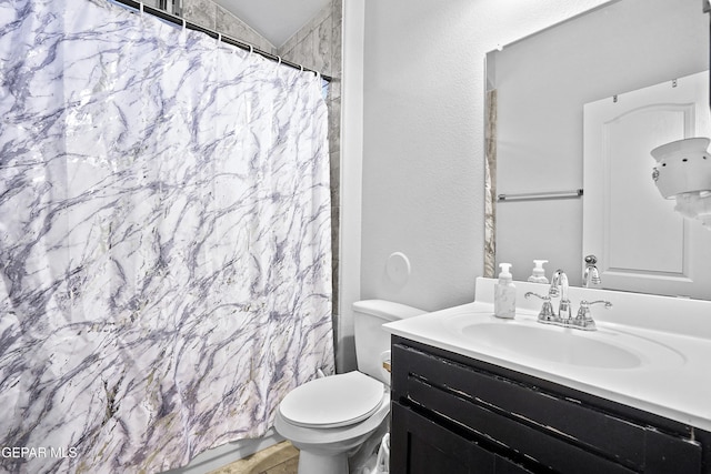 bathroom with a shower with curtain, vanity, toilet, and vaulted ceiling