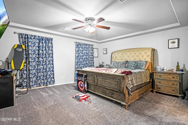 carpeted bedroom with a textured ceiling and ceiling fan