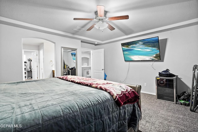 bedroom with ceiling fan, carpet floors, and a textured ceiling