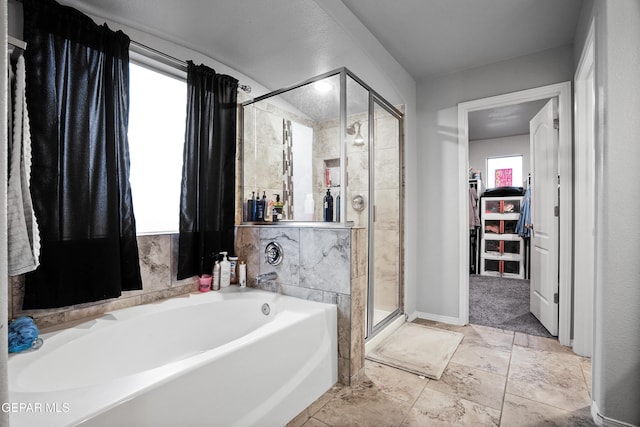 bathroom featuring shower with separate bathtub