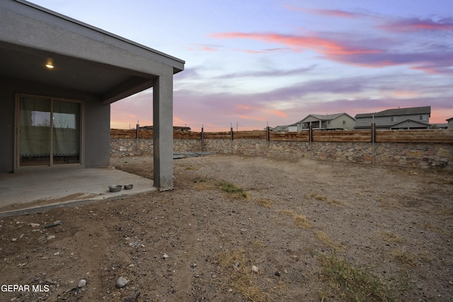 yard at dusk with a patio area