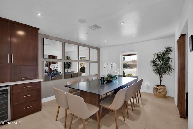 dining area featuring wine cooler and light tile patterned flooring