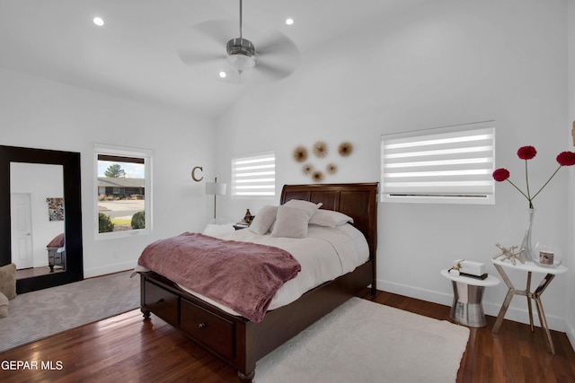 bedroom with ceiling fan, dark hardwood / wood-style flooring, and lofted ceiling