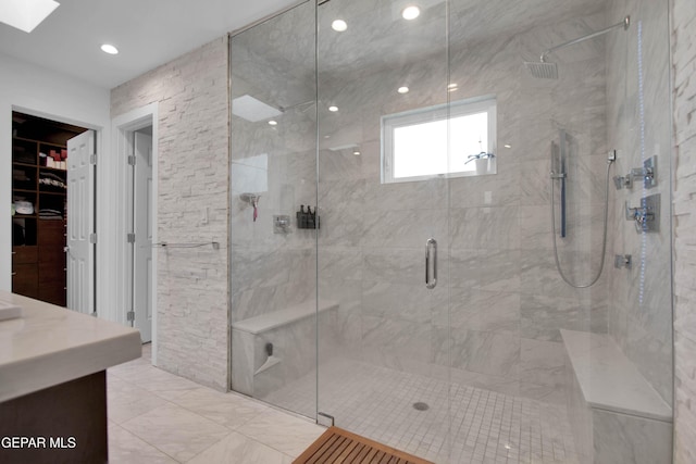 bathroom with vanity and a shower with door