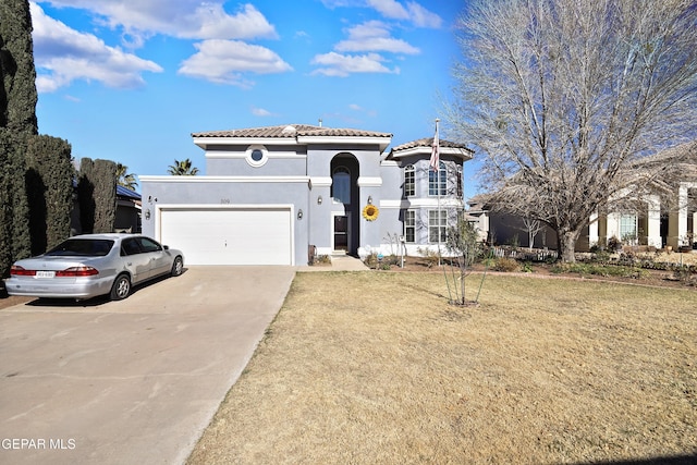 mediterranean / spanish house with a front yard and a garage