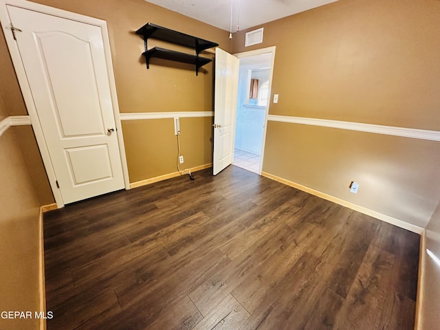 spare room with ceiling fan and dark hardwood / wood-style flooring