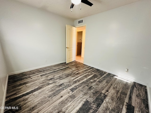 spare room featuring wood-type flooring, a textured ceiling, and ceiling fan