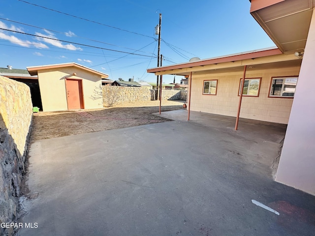 view of patio with a storage unit