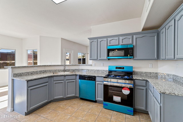 kitchen with dishwasher, stove, sink, gray cabinetry, and light tile patterned floors