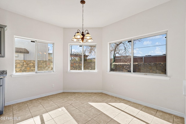 unfurnished dining area with light tile patterned flooring and an inviting chandelier