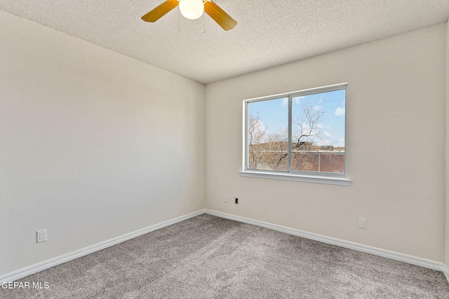 carpeted spare room with a textured ceiling and ceiling fan