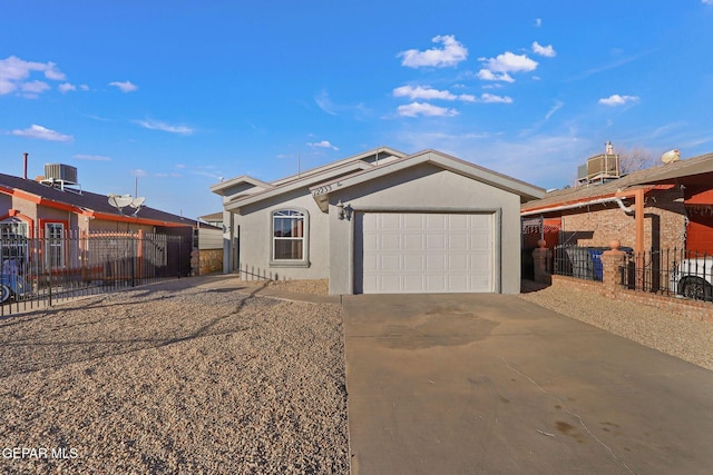 ranch-style house with a garage and central AC unit