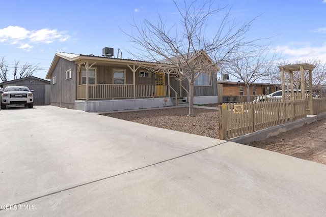 view of front of property with a porch and central AC unit